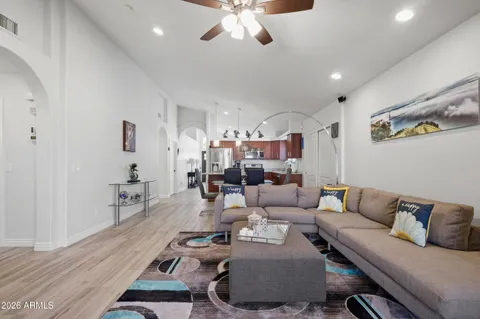 a living room with furniture and a chandelier