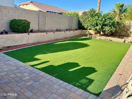 a view of a backyard with plants and a garden