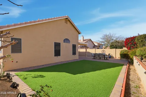 a view of a backyard with plants and a garden