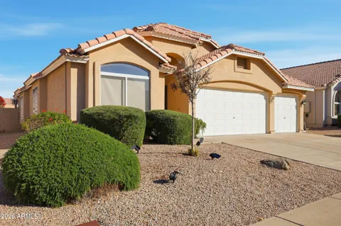 a view of a house with a small yard and plants