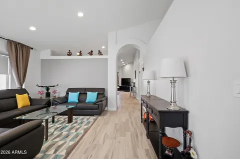 a living room with furniture and a wooden floor