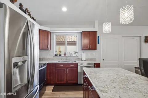a kitchen with a sink refrigerator and cabinets