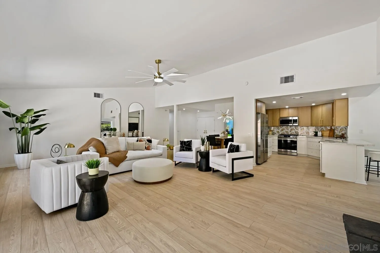 a living room with furniture and wooden floor