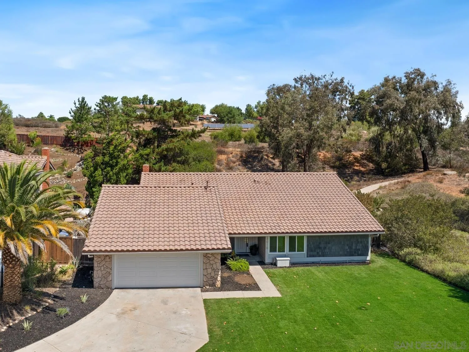 13010 Pomard Way Poway, CA 92064 - Photo 4 of 22 a view of a white house with a yard