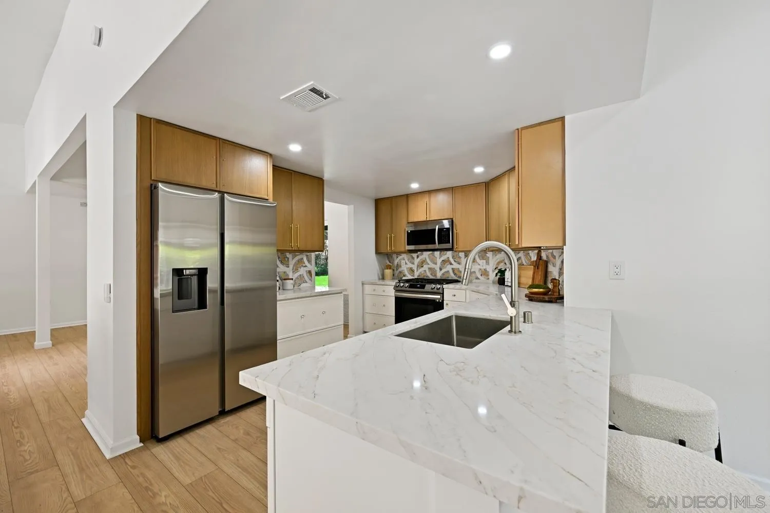13010 Pomard Way Poway, CA 92064 - Photo 6 of 22 a kitchen with granite countertop a refrigerator and a stove top oven