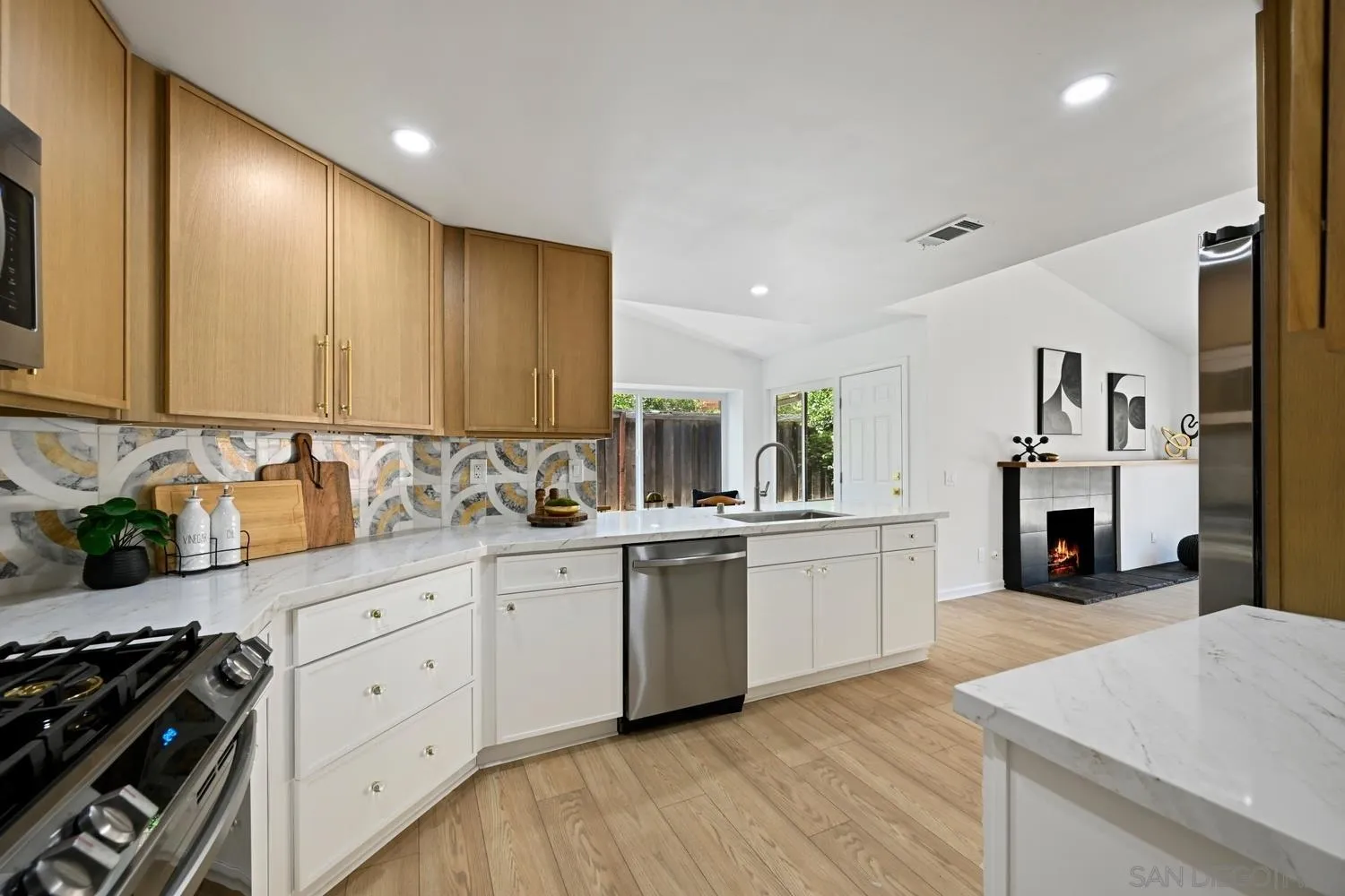 13010 Pomard Way Poway, CA 92064 - Photo 8 of 22 a kitchen with granite countertop white cabinets and white appliances
