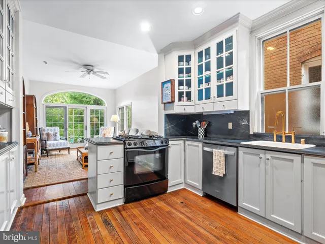 a kitchen with stainless steel appliances granite countertop a stove and a sink