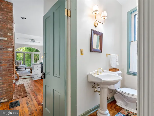 a bathroom with a sink toilet and a mirror