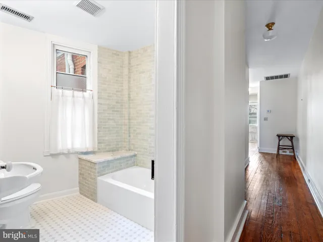a bathroom with a bathtub and a toilet