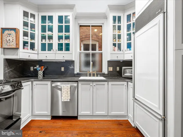 a kitchen with stainless steel appliances granite countertop a stove and a refrigerator