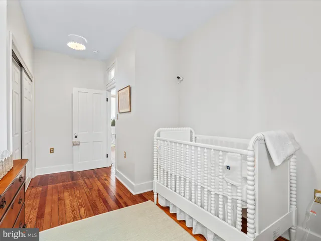 a bedroom with furniture and baby crib