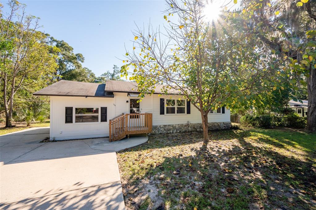 a house view with a sitting space and garden