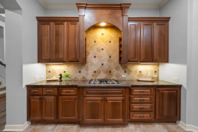 a kitchen with granite countertop a sink and cabinets