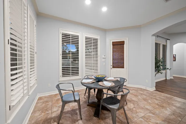 a dining room with furniture and windows