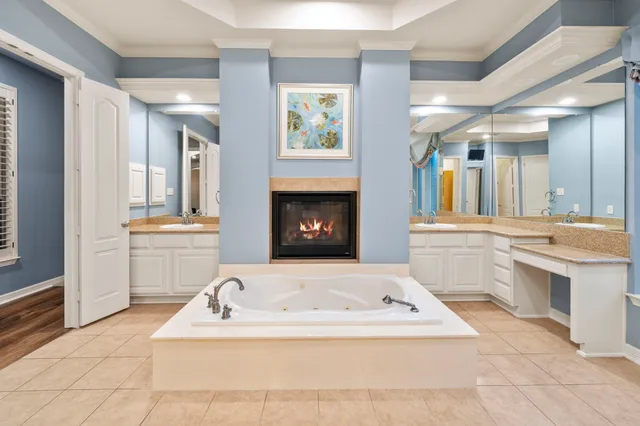 a bathroom with a sink a bathtub and a window