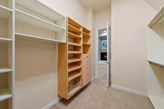a view of walk in closet with empty racks