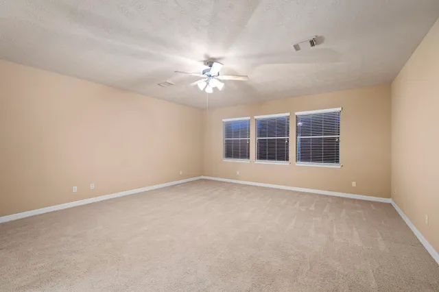 a bathroom with a bathtub shower sink vanity mirror and toilet