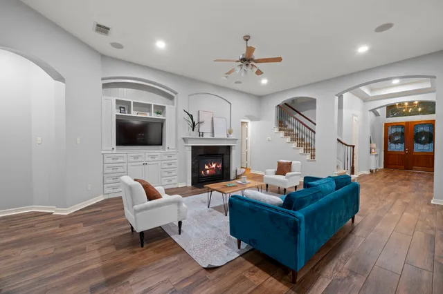 a living room with furniture fireplace and a flat screen tv