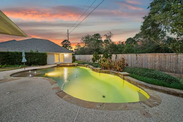 an aerial view of a house with swimming pool and outdoor space