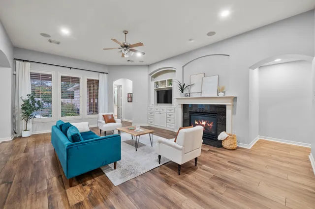 a living room with furniture and a fireplace