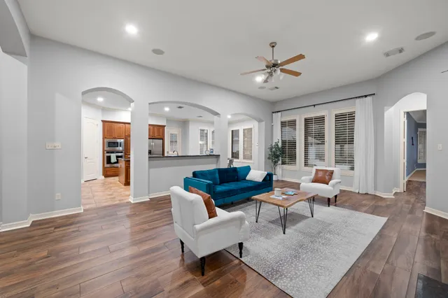 a living room with furniture and wooden floor