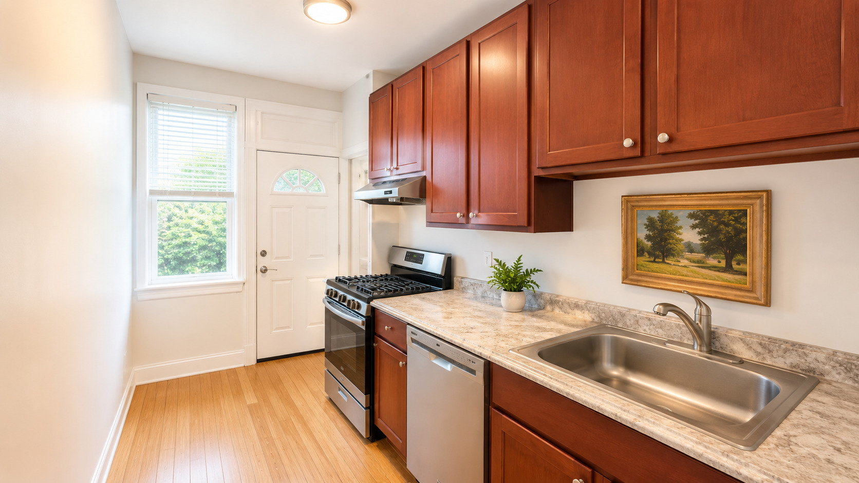 2348 West Addison Street, Unit C2 Chicago, IL 60618 - Photo 5 of 8 a kitchen with a sink stove and cabinets