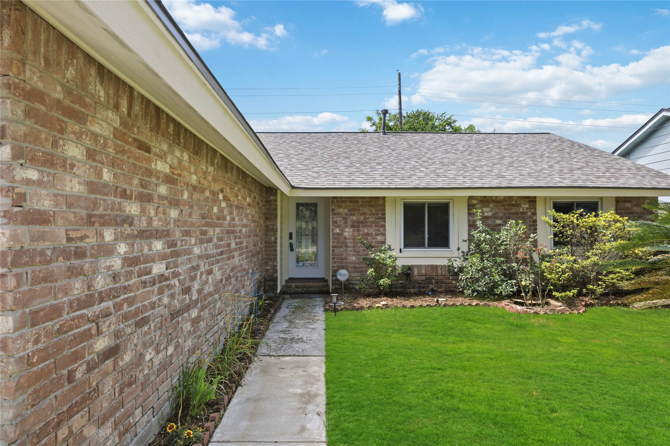 9635 Birsay Street Spring, TX 77379 - Photo 4 of 24 a front view of a house with a garden and plants