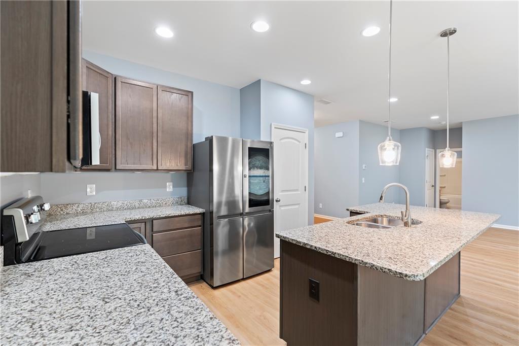 71 Moonrise Crossing Dallas, GA 30132 - Photo 11 of 64 a kitchen with a sink a counter top space and stainless steel appliances
