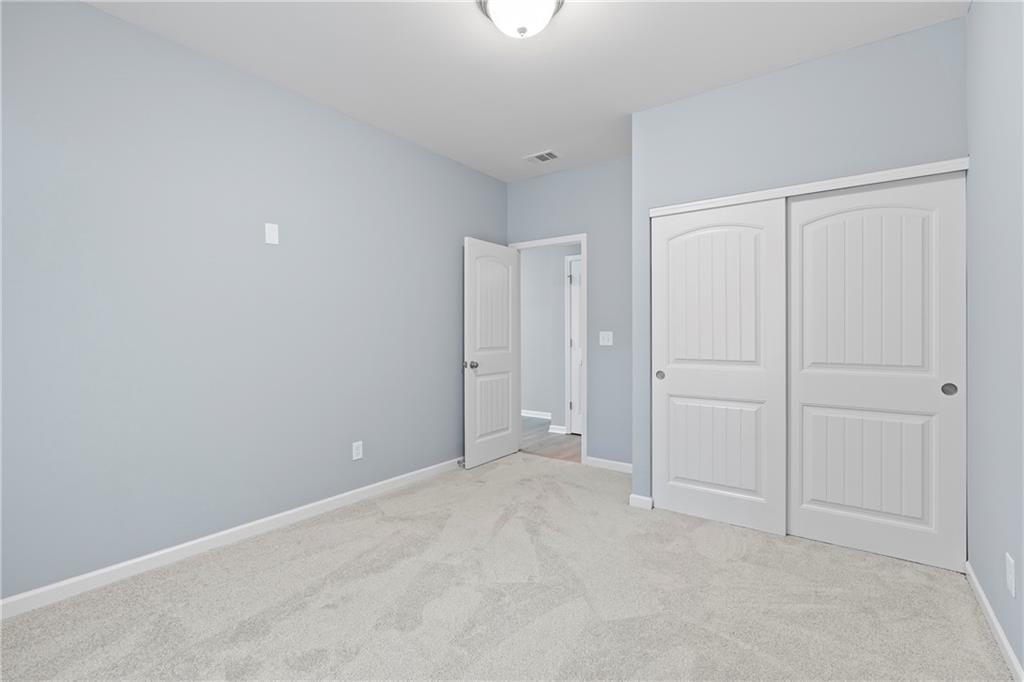 71 Moonrise Crossing Dallas, GA 30132 - Photo 13 of 64 a view of an empty room with windows