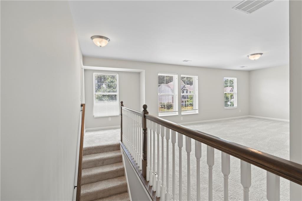 71 Moonrise Crossing Dallas, GA 30132 - Photo 24 of 64 a view of a hallway with wooden floor and entryway