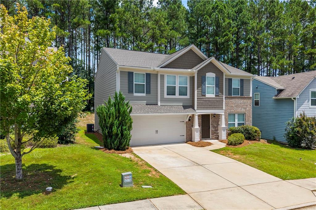 71 Moonrise Crossing Dallas, GA 30132 - Photo 3 of 64 a front view of a house with garden