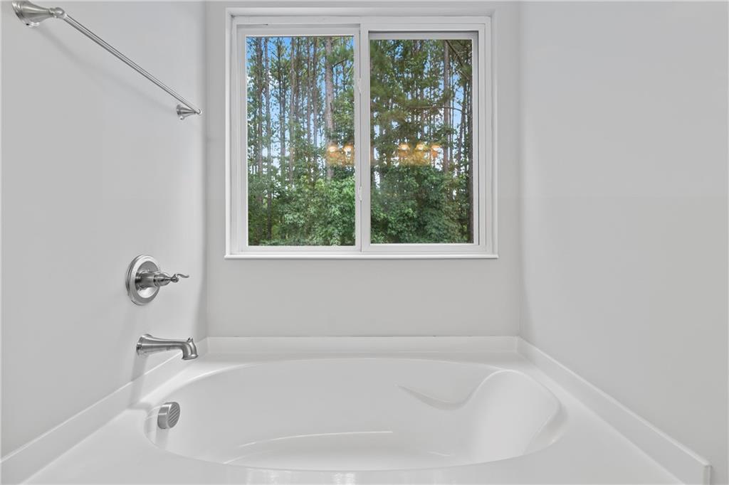 71 Moonrise Crossing Dallas, GA 30132 - Photo 31 of 64 a white bath tub sitting next to a window