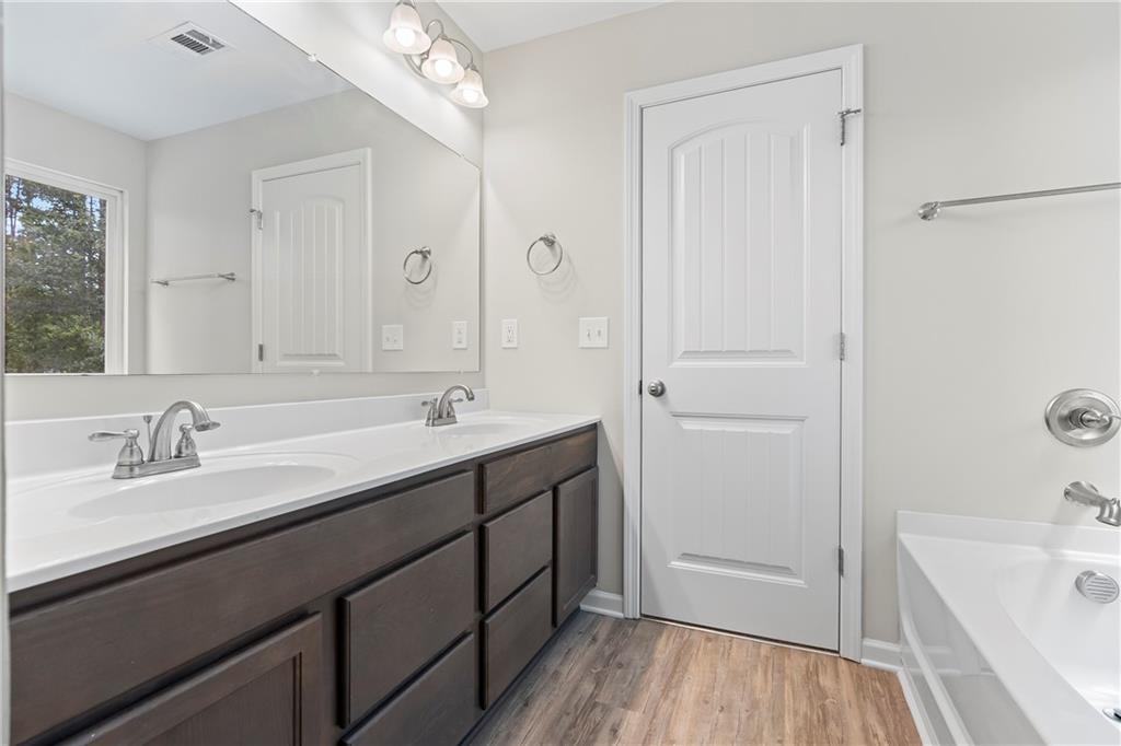 71 Moonrise Crossing Dallas, GA 30132 - Photo 32 of 64 a bathroom with a tub a sink and mirror
