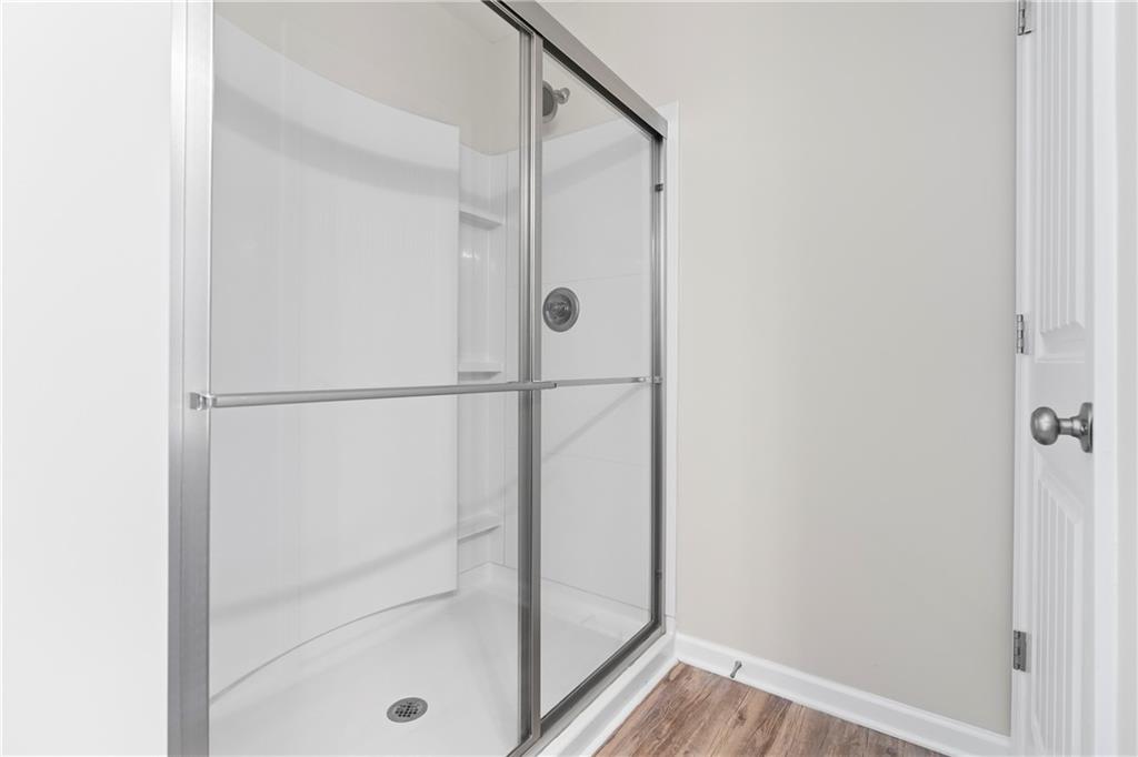 71 Moonrise Crossing Dallas, GA 30132 - Photo 33 of 64 a bathroom with a glass shower door
