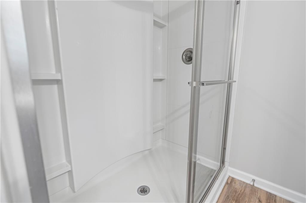 71 Moonrise Crossing Dallas, GA 30132 - Photo 34 of 64 a bathroom with a glass shower door