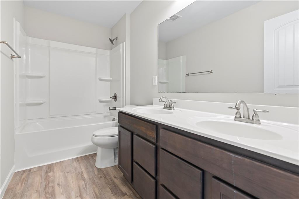 71 Moonrise Crossing Dallas, GA 30132 - Photo 44 of 64 a bathroom with a double vanity sink toilet mirror and bathtub