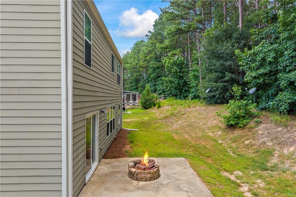 71 Moonrise Crossing Dallas, GA 30132 - Photo 51 of 64 a yellow house with trees in front of it