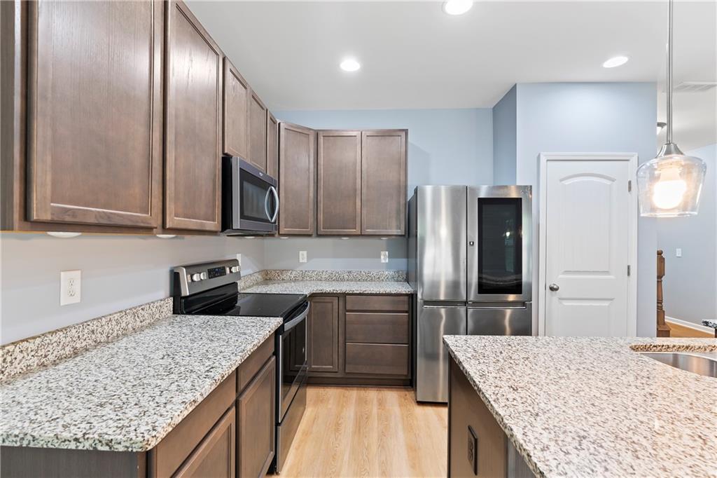 71 Moonrise Crossing Dallas, GA 30132 - Photo 8 of 64 a kitchen with stainless steel appliances granite countertop sink microwave and refrigerator