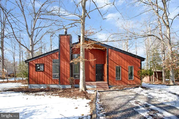 a view of a house with snow on the road
