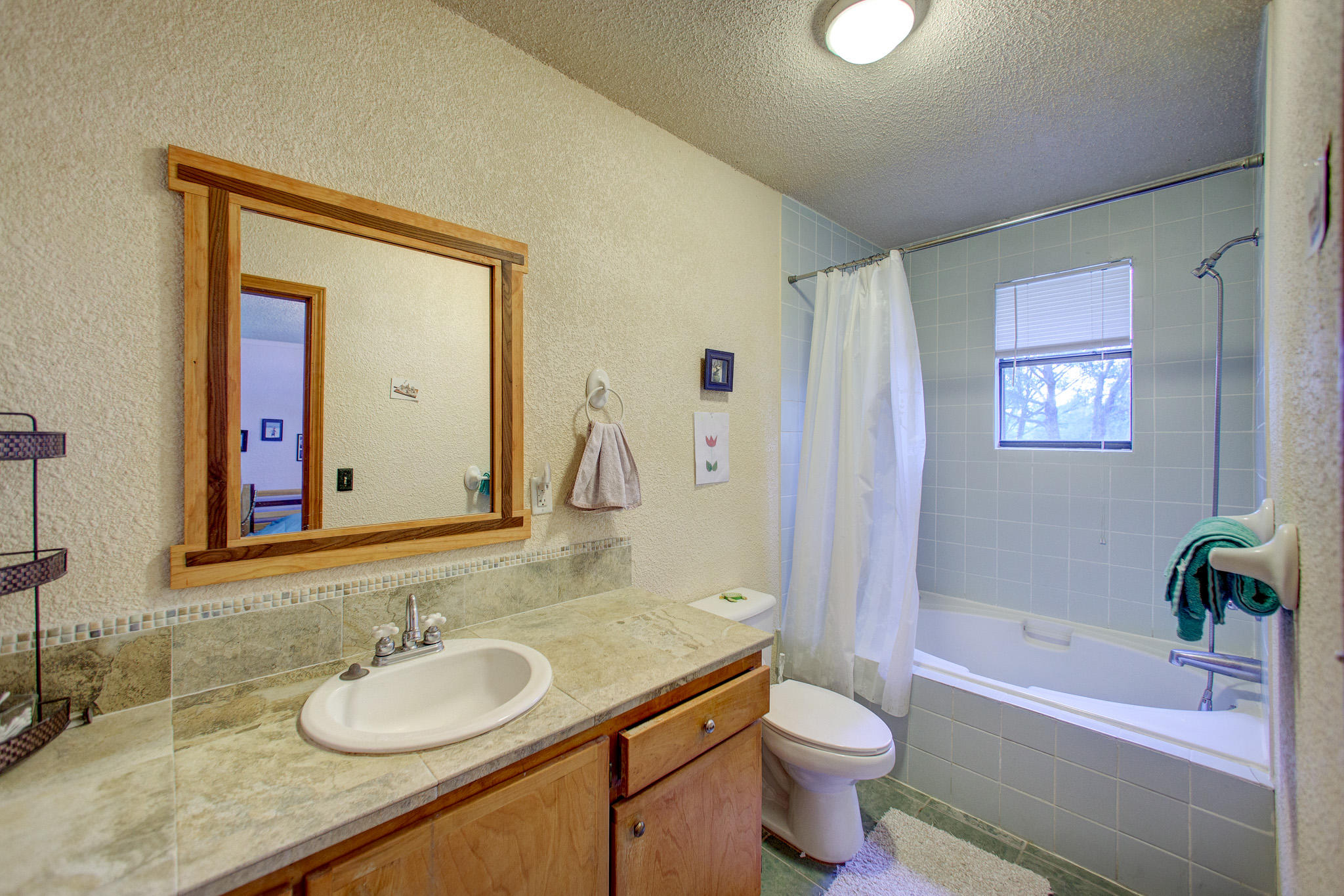 5200 Yohn Road Baker, FL 32531 - Photo 22 of 29 a bathroom with a granite countertop sink toilet and shower