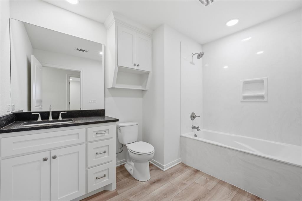 2303 Pilgrim Lane Lorena, TX 76655 - Photo 22 of 38 a spacious bathroom with a granite countertop toilet a sink and a mirror