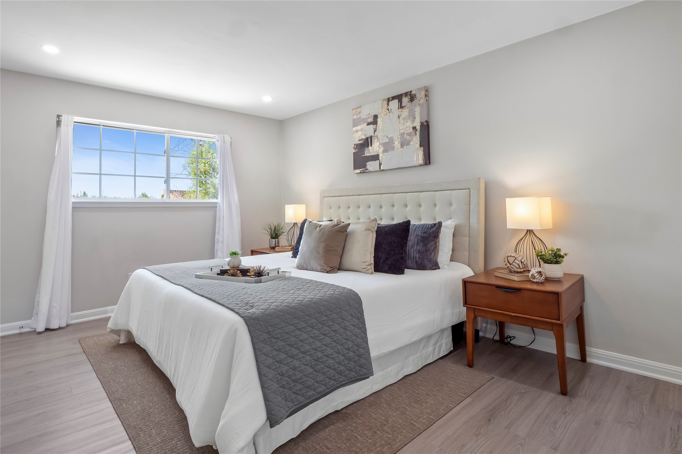 8007 Colony Loop Drive Austin, TX 78724 - Photo 20 of 40 Bright primary bedroom with wide window, fresh paint, recessed lighting, and private en suite bath.
