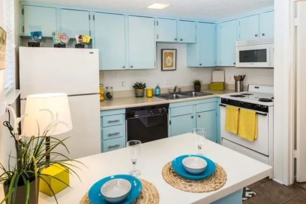 a kitchen with a sink a stove and refrigerator