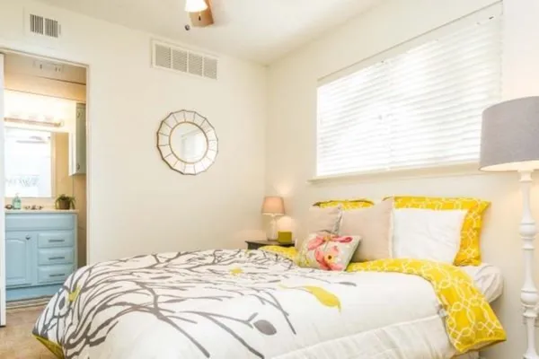 a bedroom with a bed and a window