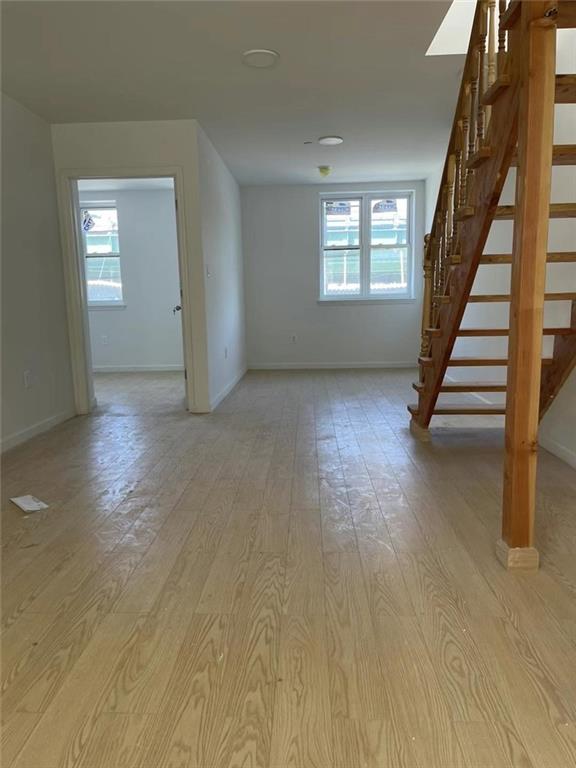 4313 3rd Avenue Brooklyn, NY 11232 - Photo 2 of 5 wooden floor and windows in an empty room