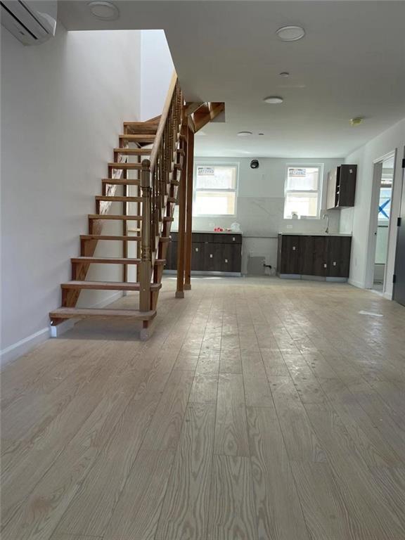 4313 3rd Avenue Brooklyn, NY 11232 - Photo 4 of 5 wooden floor in an empty room with stairs