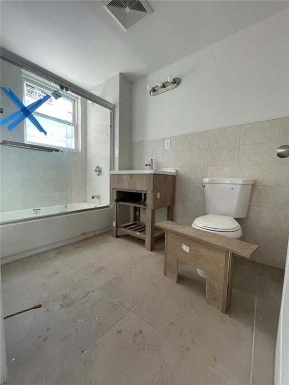 4313 3rd Avenue Brooklyn, NY 11232 - Photo 5 of 5 a bathroom with a toilet a sink and a mirror