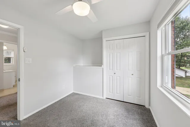 a view of an empty room and a window