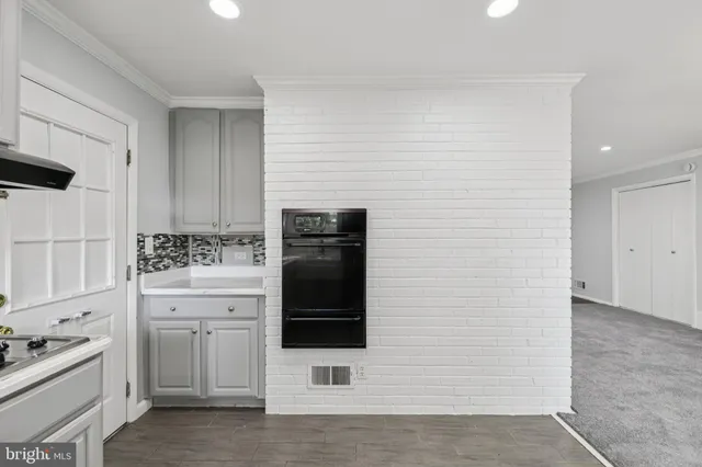 a kitchen with white cabinets and appliances