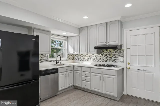 a kitchen with a sink stove and refrigerator